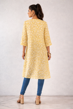 High-low asymmetric tunic with a wrap-effect front slit.