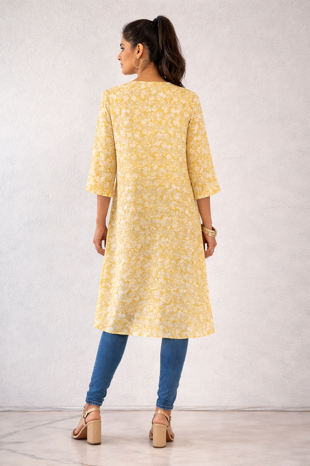 High-low asymmetric tunic with a wrap-effect front slit.