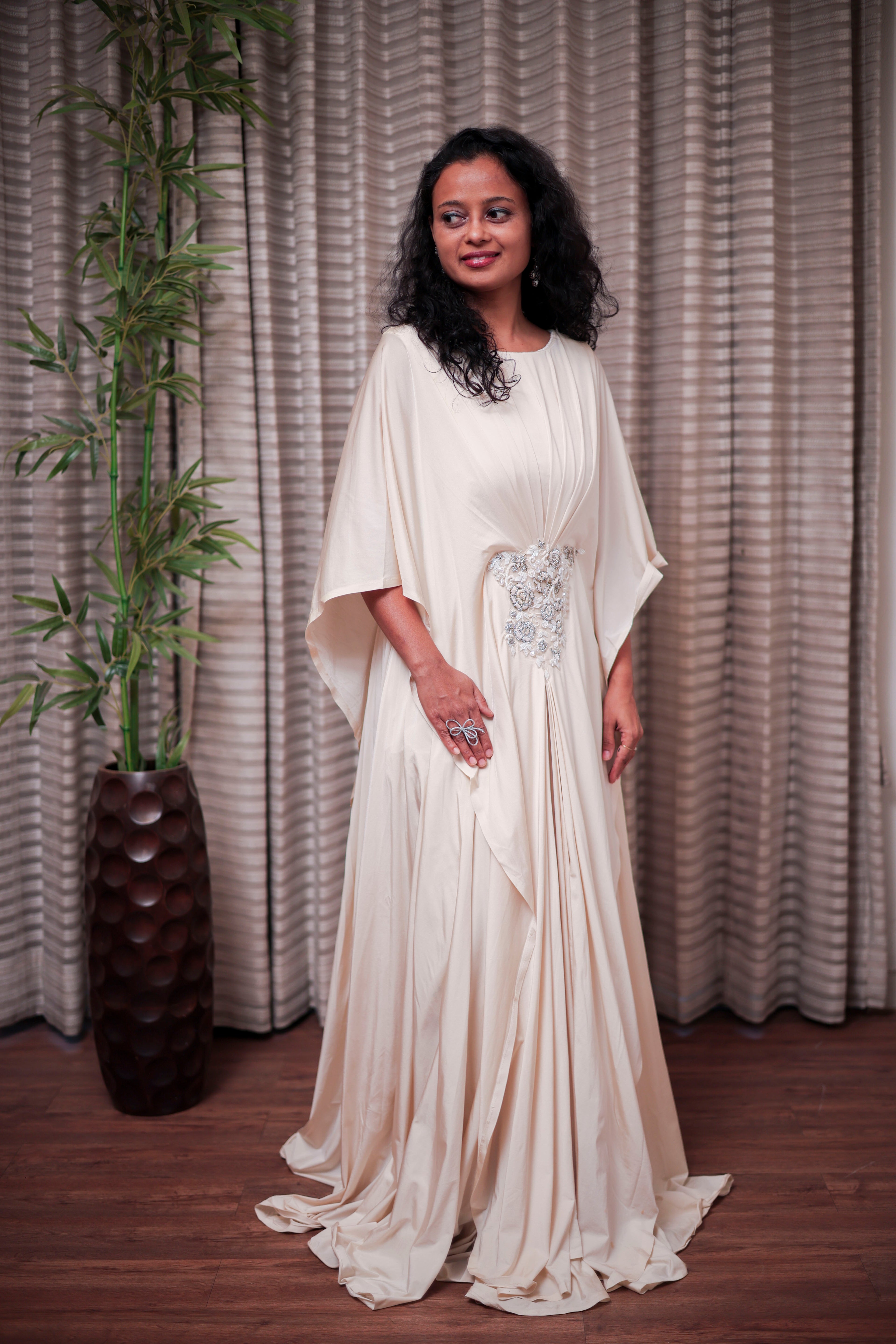 Boho-Chic Elegance: Flowing Cream Gown with Statement Embellishment
