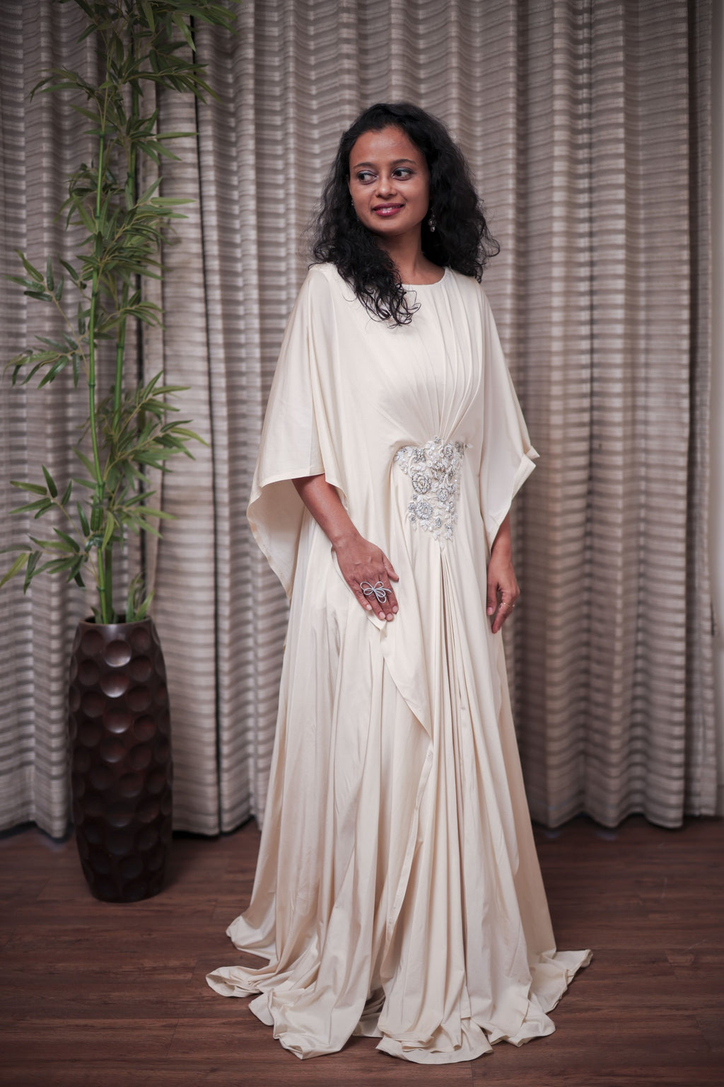 Boho-Chic Elegance: Flowing Cream Gown with Statement Embellishment