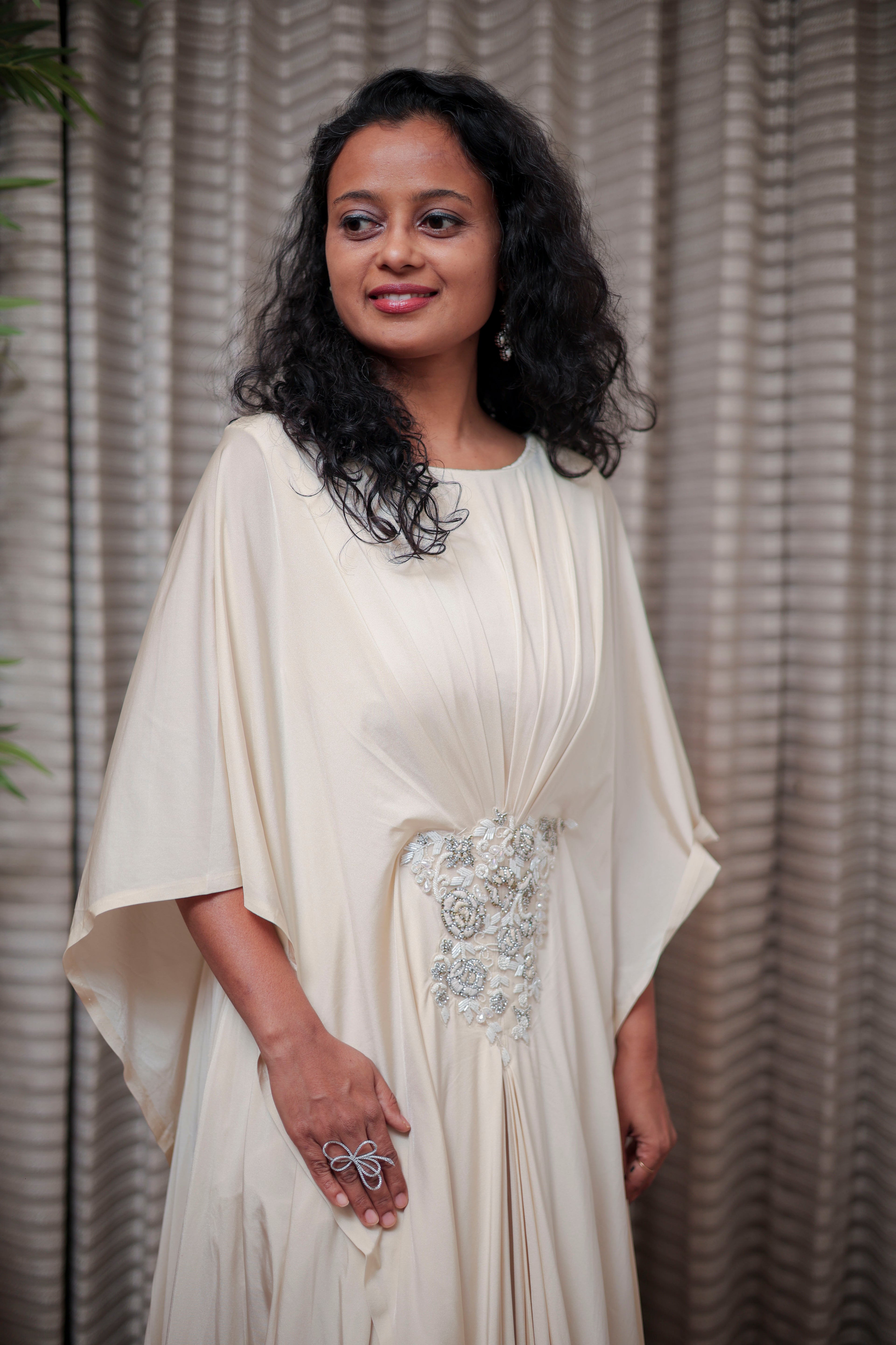 Boho-Chic Elegance: Flowing Cream Gown with Statement Embellishment
