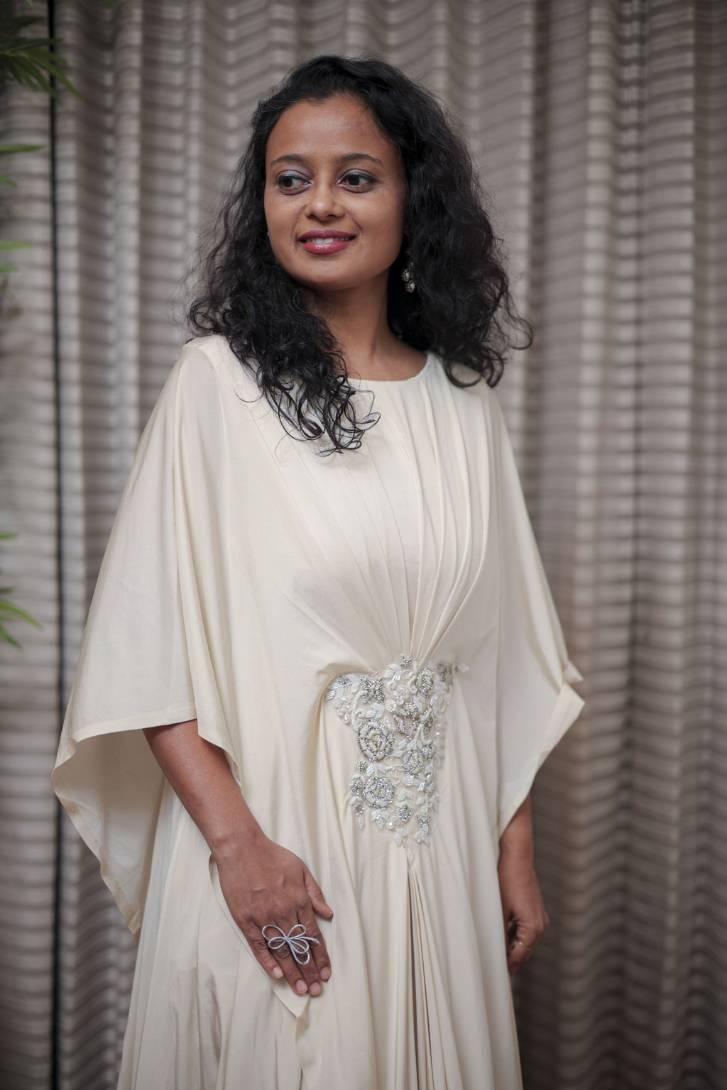 Boho-Chic Elegance: Flowing Cream Gown with Statement Embellishment